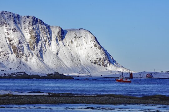 Fishing boat, winter landscape, last evening sun, Ramberg, Flakstadoya, Nordland, Lofoten, Norway