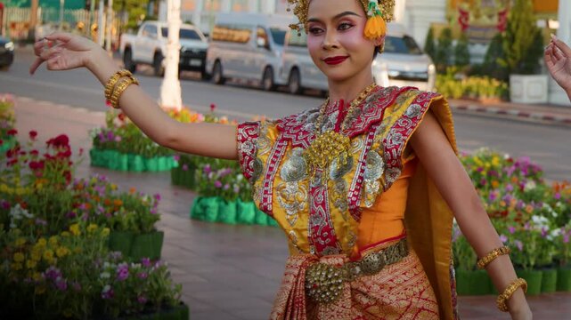 Thai Classical Dancer in Traditional Chut Thai Costume Performing Outdoors