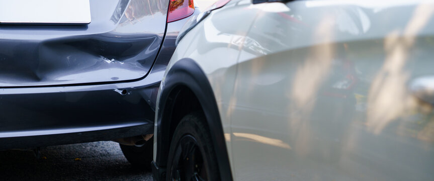 Close up of damaged rear bumper of grey car after rear end crash