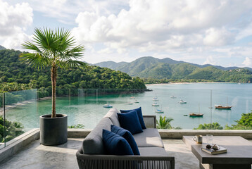 Obraz premium Modern balcony lounge with sofa overlooking tropical bay