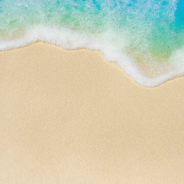 sandy beach on the shore of a tropical island under the foaming waves of a turquoise ocean