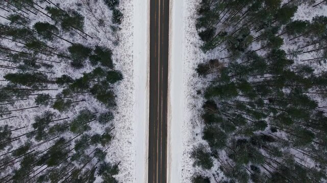 Drone tracks blue car along P5 highway beside Nature Park The Ogre Blue Hills