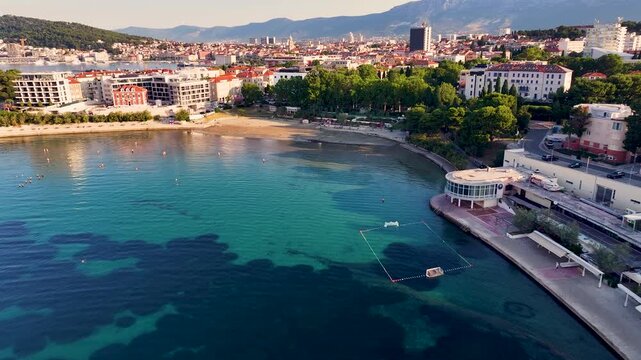 Incredible aerial view of the famous baсvice beach and split cityscape in croatia, with clear turquoise adriatic sea and mountains