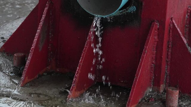 Rainwater is coming out of an iron pipe