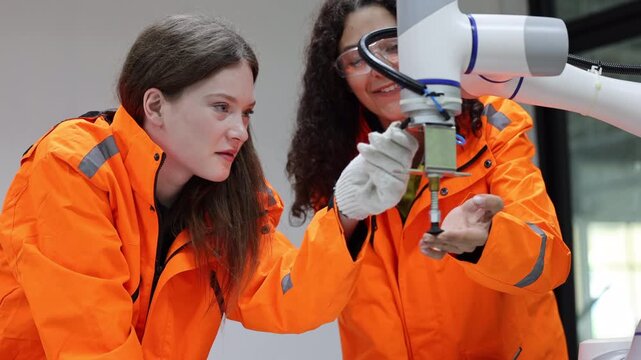 Female industrial engineer study inspection control robot arm machine in robotics engineering, Robotic learn operating, programming, troubleshooting quality control demonstrations of robotic arms. AI