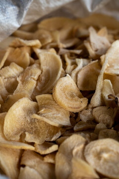 Close up of dried tapioca chips (cassava) - traditional sun dried root food ingredient background.