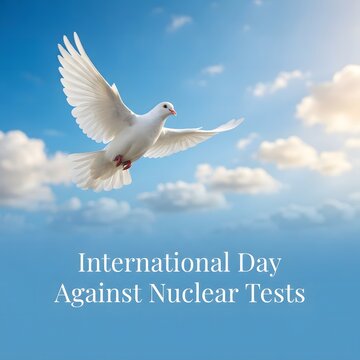 White dove flying in the blue sky for international day against nuclear tests concept