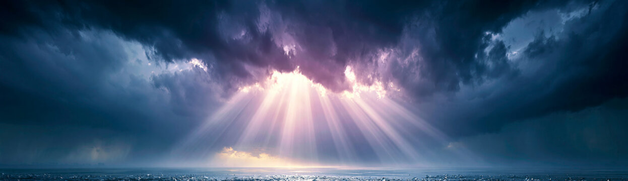 Dark storm clouds open to reveal radiant sunbeams shining down over a calm ocean horizon.