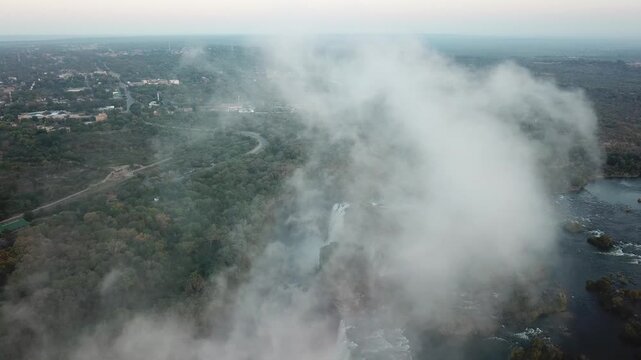 Aerial view of Victoria Falls with massive mist rising over the Zambezi River