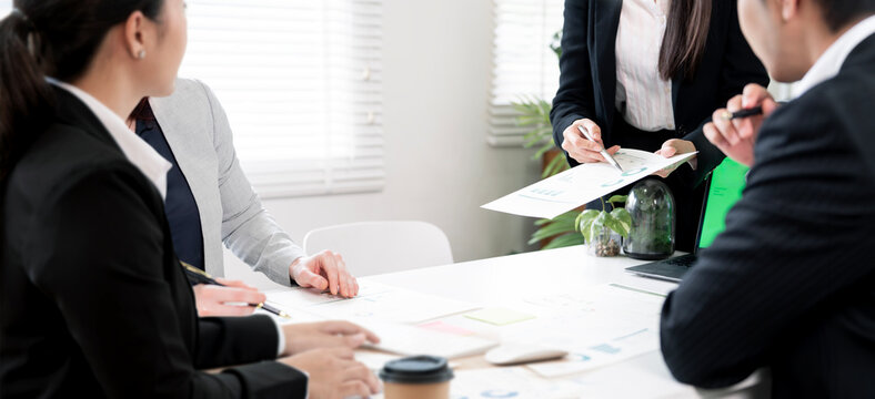Business people discussing document during meeting in modern office