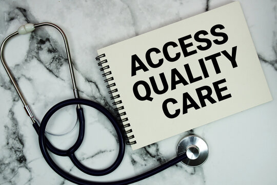 Access Quality Care text written on notepad with stethoscope and magnifying glass on marble background