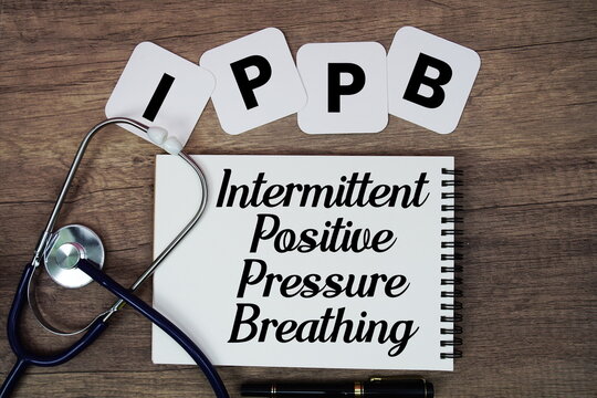 IPPB Intermittent Positive Pressure Breathing text written on notepad with stethoscope on wooden background