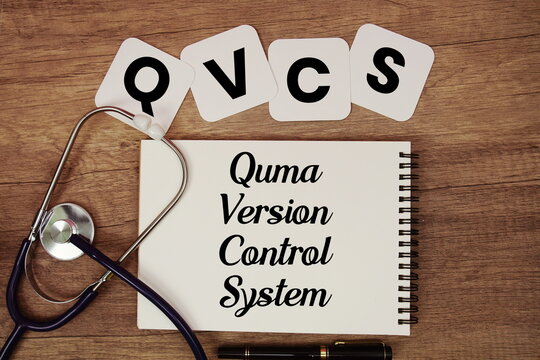 QVCS  Quma Version Control System text written on notepad with stethoscope on wooden background