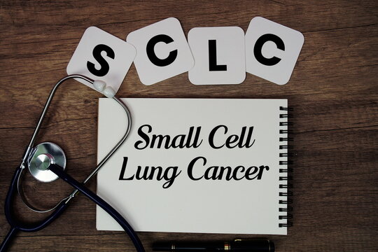 SCLC Small Cell Lung Cancer text written on notepad with stethoscope on wooden background
