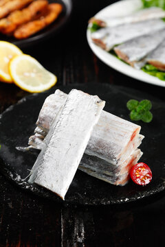 Fresh Frozen Striped Bass Fillets with Lemon on Dark Slate - Wild Seafood Studio Photography