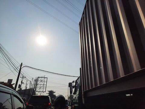 Low angle shot of shipping container box mounted on semi truck trailer chassis