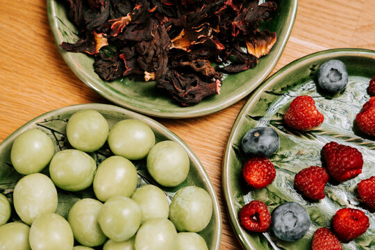 Fresh fruit and hibiscus on a wooden table in morning light