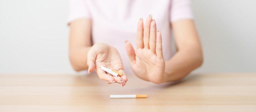 woman hand break cigarette for World No Tobacco Day concept, quitting smoking to prevent Lung Cancer, COPD, Emphysema and Tuberculosis disease. healthy lifestyle resolution, stop nicotine addiction