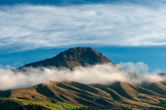 Majestic El Coraz&oacute;n Volcano at Sunrise Among Clouds in the Andes