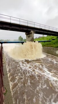 The rapid flow of water at the dam. Heavy rains, heavy flooding, lots of water. Global warming