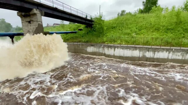 The rapid flow of water at the dam. Heavy rains, heavy flooding, lots of water. Global warming