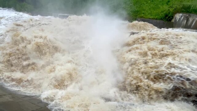 The rapid flow of water at the dam. Heavy rains, heavy flooding, lots of water. Global warming