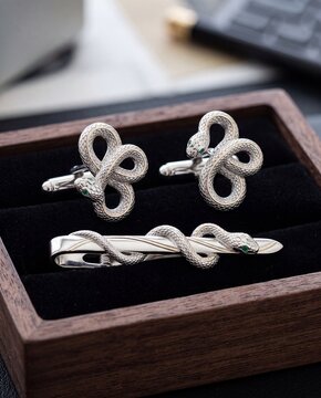A men's jewelry set with a pair of snake cufflinks and an elegant snake-shaped tie clip