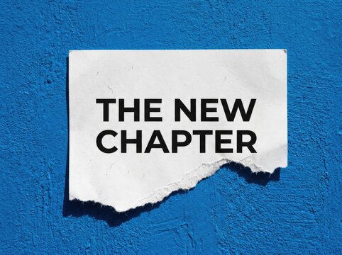 Torn paper with "THE NEW CHAPTER" text, symbolizing a fresh start or a turning point in life or business, against a vibrant blue textured background.