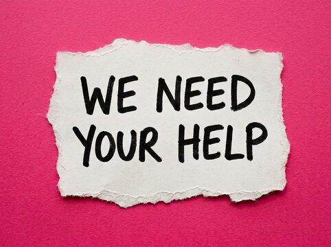 We Need Your Help note, distressed paper on pink background, a plea for support and assistance.