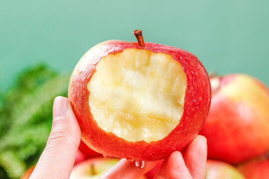 Hand Holding Bitten Red Apple Close Up