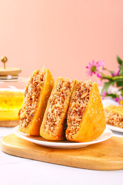 Traditional Huazhou Tolo Cake Cantonese Specialties with Sesame Seeds and Coconut Filling on Wooden Board