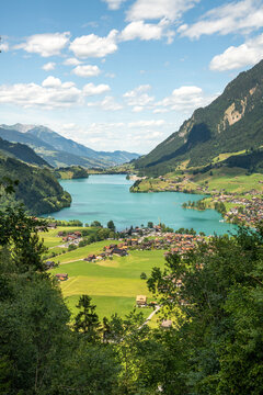 Lungern, Switzerland. Vertical panoramic view of Lake Lungern and the Swiss Alps from Ch&auml;lr&uuml;tirank Viewpoint in summer
