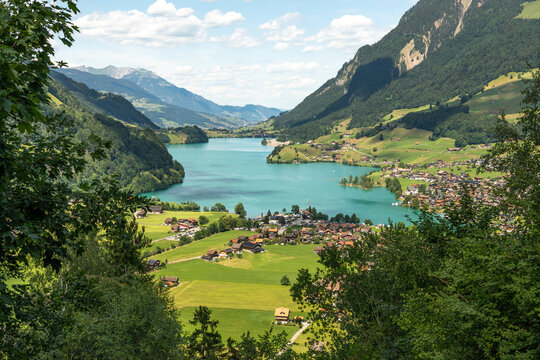 Lungern, Switzerland. Panoramic view of Lake Lungern and the Swiss Alps from Ch&auml;lr&uuml;tirank Viewpoint on a sunny summer day