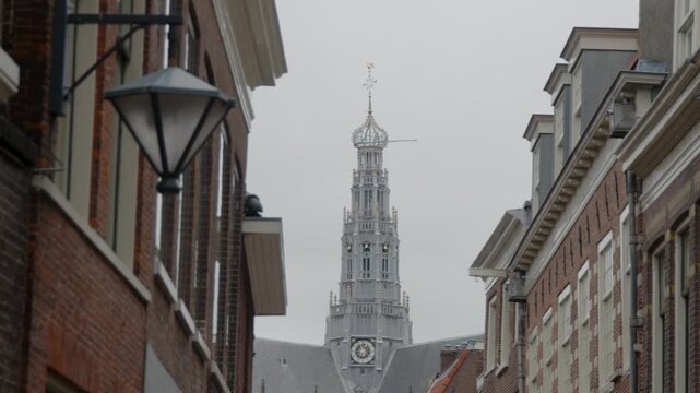 Pull focus from street light to distant clock tower of St. Bavos Cathedral in Haarlem, Amsterdam