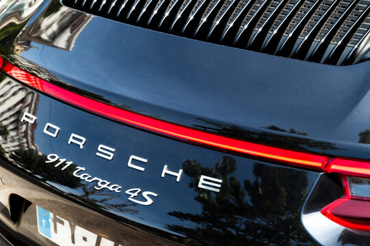 luxury black Porsche 911 Targa 4S sports car parked on a sunny street