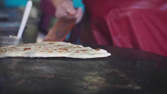 Making flatbread in an outdoor kitchen
