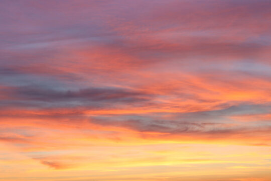 Beautiful Dramatic Sunset Sky with Glowing Orange and Red Clouds and Sun Rays.