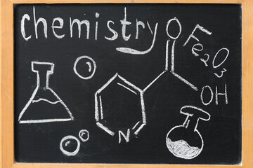 Obraz premium Drawn molecular structure, formulas, testing tubes and word CHEMISTRY on black chalkboard