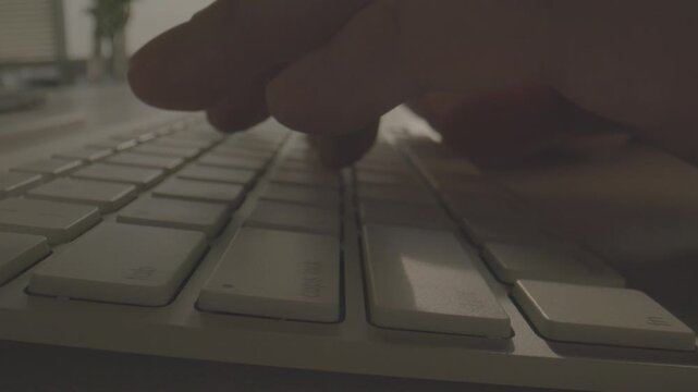An extreme close-up of individual white keyboard keys showing the texture and detail of the keys in soft lighting.
