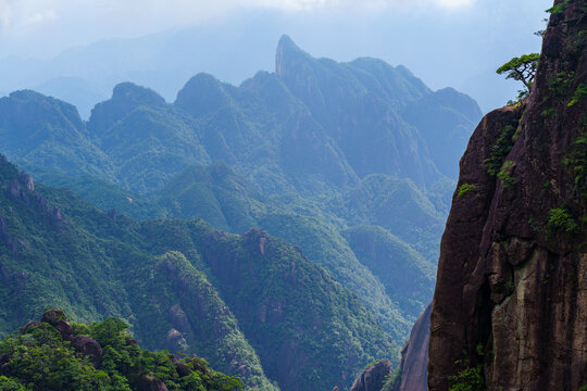 A scenic view of the lush green peaks and rocky cliffs at Sanqingshan Mountain in Jiangxi province of China on a clear day
