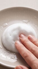 Fototapeta premium Fingers pressing into white soap lather