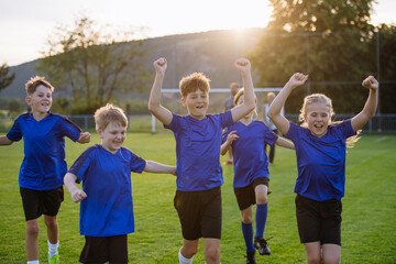 Fototapeta premium Young football team celebrating goal.