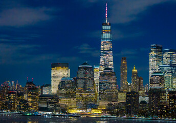 Naklejka premium NYC skyline at night. NYC waterfront night view. New York City night skyline. NYC downtown night cityscape.