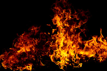 Fototapeta premium Fire burns with bright flame. Fire glows above hot flame. Realistic fire for design. Burning fire on black.