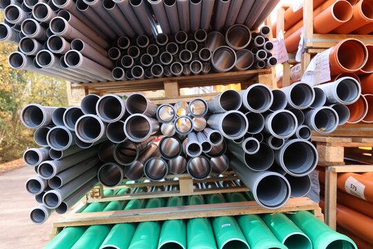 Assorted PVC and plastic pipes in storage