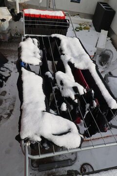 Clothes drying rack covered in snow outdoors