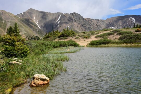 looking east from  scenic pass lake at the continental divide and the colorado rocky mountains,  near loveland pass  on a sunny  summer day in  colorado  