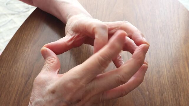 Senior woman's hand doing finger exercise for joint mobility and arthritis care