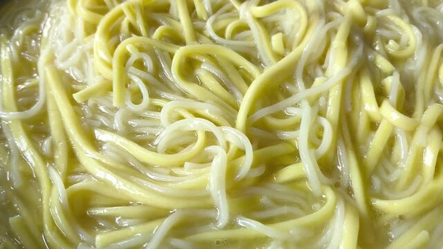 Boiling noodles in pan, indoor Chiangmai Thailand.