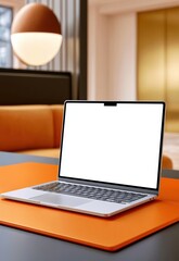 Fototapeta premium Modern laptop on a desk in a cozy workspace with a blank screen and orange desk pad